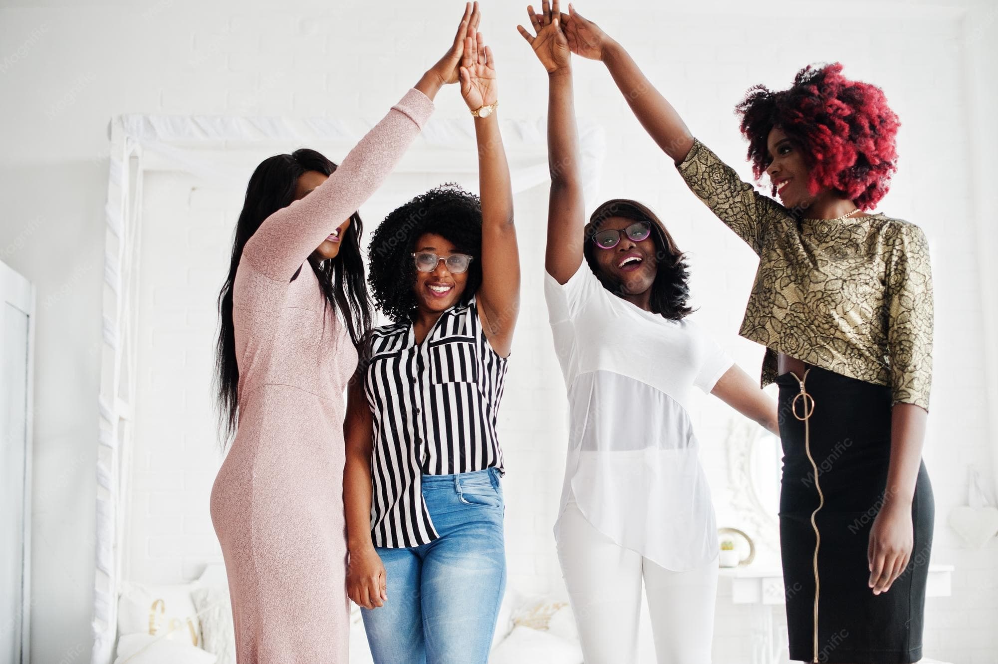 Four friends — hands together in unity